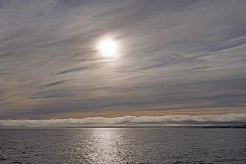 High and Low Clouds on the Ocean Stockfoto's