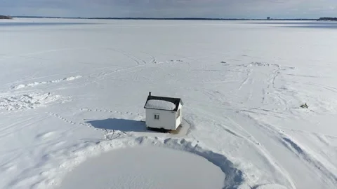 High and slow point-of-interest drone flight over the ice fishing cabin Stock-Footage 164382217