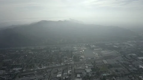 High and Wide Pullback from Freeway and Mountain in the Clouds Stock Footage 131285992