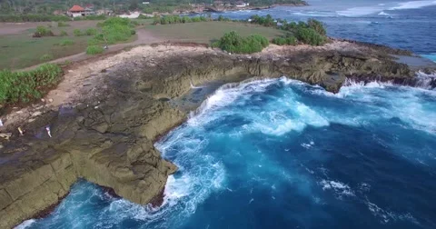 HIGH ANGLE 4K AERIAL OF HUGE WAVES CRASHING ON LIMESTONE ROCKS Stock Footage 60006308