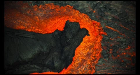 High Angle 4K Real Lava Surrounding Dark Volcanic Rock Vídeo Stock 332352844