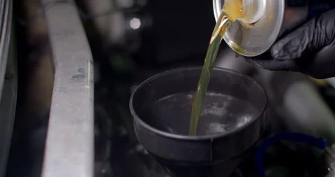 High angle add new engine oil to the engine.Change new oil to the car engine. Stock Footage 295800091