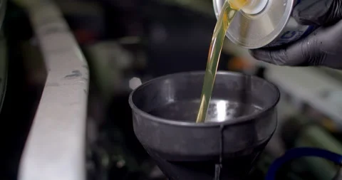 High angle add new engine oil to the engine.Change new oil to the car engine. Stock Footage 302111964