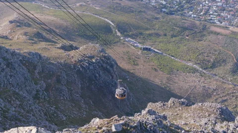 High angle: Aerial cable car travelling up Table Mountain Stock Footage 242012965