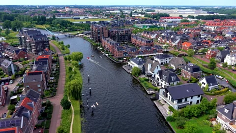 High-angle aerial drone clip of modern waterfront residential district Stock Footage 347030281
