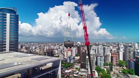 High Angle Aerial Drone Jib Up of Crane Lifting Water Tank at Construction Site Stock Footage 342729284