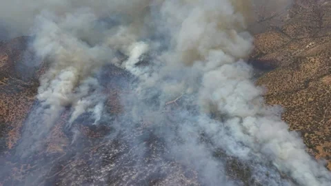High-angle aerial drone shot looking directly down into thick, billowing Stock Footage 328158053