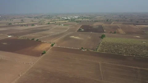 High angle aerial drone shot over vast open agricultural landscapes during the Stock Footage 336943802