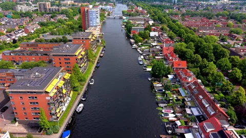 High angle aerial drone video clip of urban river canal, modern apartments Stock Footage 342416720