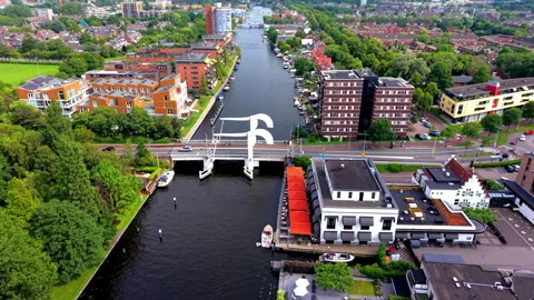 High angle aerial drone video clip of white drawbridge spanning urban river Stock Footage 342426440