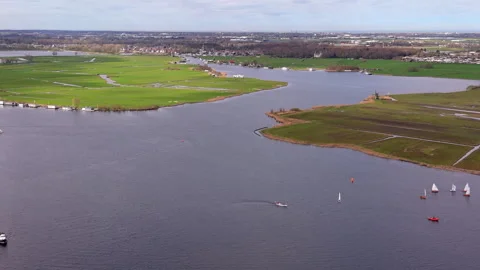 High angle aerial drone video clip of sailboats cruising on wide lake Stock Footage 342439998