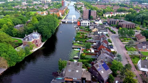 High angle aerial drone video clip of white drawbridge spanning urban river Stock Footage 342443323