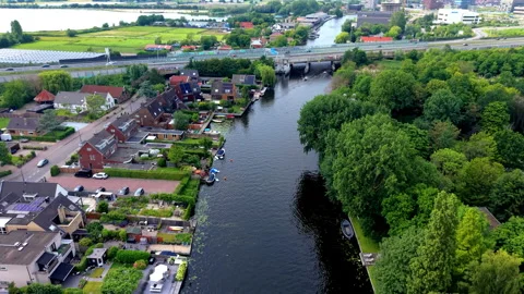 High angle aerial drone video clip of urban river canal, waterfront restaurant Stock Footage 342443393