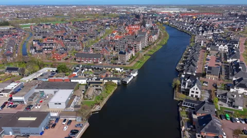 High-angle aerial drone view of a scenic canal curving through a modern Stock Footage 337706650