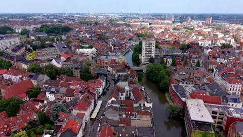 High-angle aerial drone view of Ghent cityscape with a winding river canal Stock Footage 337910541