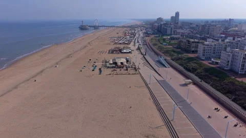 High-angle aerial drone view of a vast sandy coastline, modern multi-level .. Stock Footage 337933894