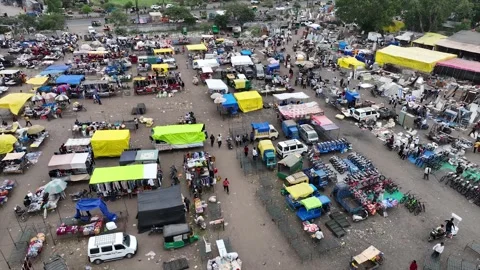 High Angle Aerial Drone View of Bustling Sunday Flea Market Stalls and Shoppers Stock Footage 346004059