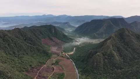 High-angle aerial drone view of a winding river flowing through a deep valley Stock Footage 346012254