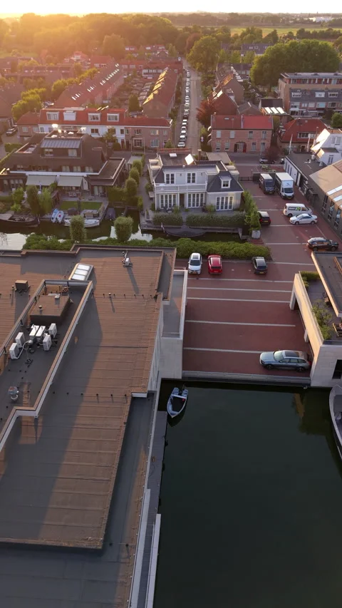 High-angle aerial drone view of modern luxury waterfront apartment 動画素材 347160267