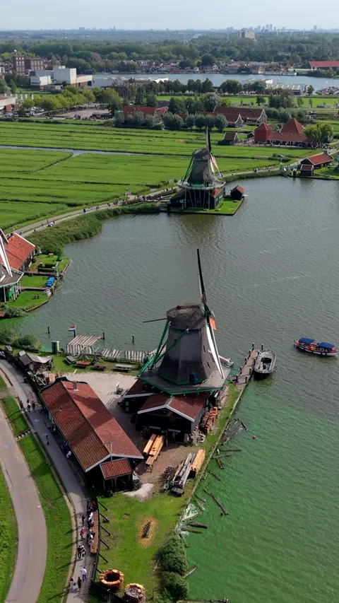 High-angle aerial drone view of historic Zaanse Schans windmills along 動画素材 347163199