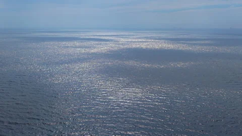 High-angle aerial drone view of shimmering North Sea open water surface 動画素材 347328747