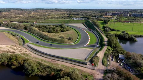 High-angle aerial drone view of Circuit Zandvoort race track sharp hairpin Vídeo Stock 347527886
