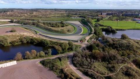High-angle aerial drone view of Circuit Zandvoort race track sharp hairpin 動画素材 347528129