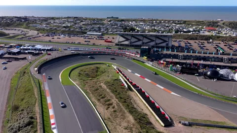 High-angle aerial drone view of Circuit Zandvoort race track banked turn Video stock 347531343