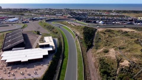 High-angle aerial drone view of Circuit Zandvoort race track curved section Stock Footage 347531516