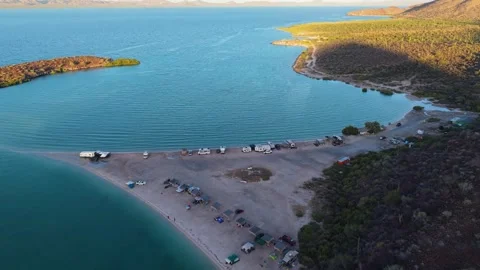 High Angle Aerial Flight Over Camper Vans and RV Camping on Playa El Requeson Stock Footage 338432985