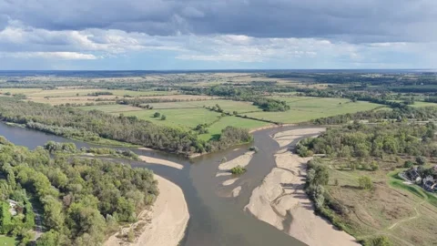A high-angle aerial shot captures the confluence of two rivers at Bec dAllier Stock Footage 346702112