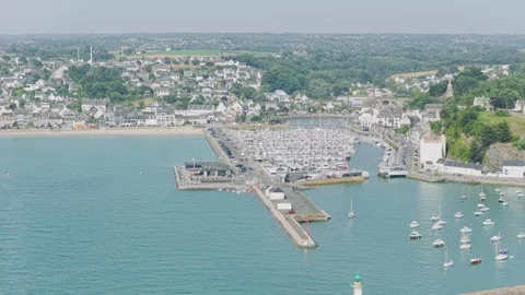 A high-angle aerial shot of the marina and waterfront in Binic, a coastal town Stock Footage 346677139