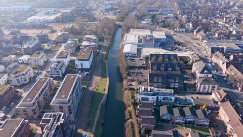High angle aerial shot of a modern European city featuring a canal industrial Stock Footage 330047149