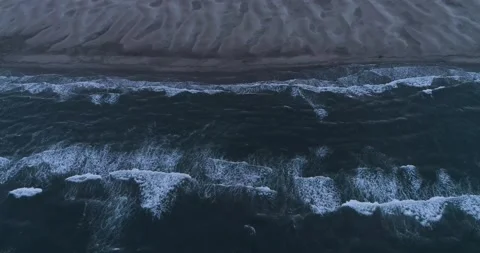 High angle Aerial shot of waves breaking on the beach. Slow motion movement Stock Footage 201060279