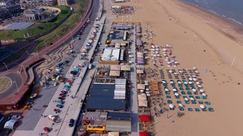 High-angle aerial view of a busy coastal beach resort featuring Stock Footage 337911210