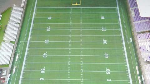 High angle aerial view of empty football field with yard markings and bleachers 動画素材 342204804