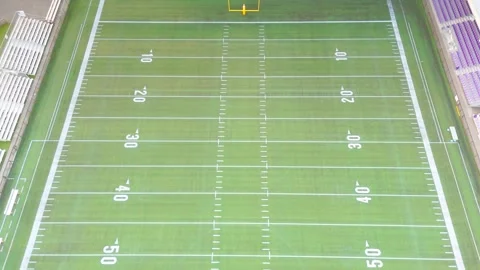 High angle aerial view of empty football field with yard markings and bleachers Stock Footage 342205385