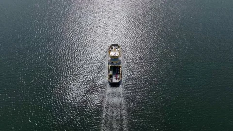 High-angle aerial view of a ferry vessel in a sea carrying vehicles Stock Footage 239869827