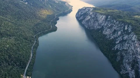 High angle aerial view flying over a vast river gorge. Steep rocky cliffs and a Stock Footage 344729017