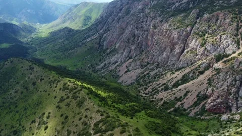 High angle aerial view of grand mountain canyon and sheer cliffs in Kazakhstan Видео 337119924