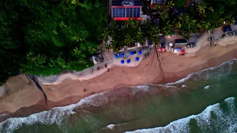 High-angle aerial view of Madiha Beach shows waves lapping onto a sandy 库存影片 331406215