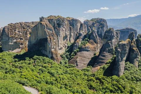 High angle aerial view of massive rock formations rising above green valley.. Stock Photos