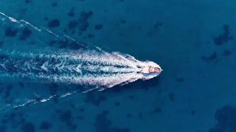 High Angle Aerial View of Motorboat Navigating Deep Turquoise Sea in Corfu Stockbeeldmateriaal 345002416