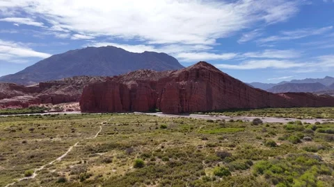 High-angle aerial view of red rock formation and grassy valley in Salta Argentin Stock Footage 342841655
