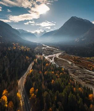High angle aerial view of river and road running through forest and mountainous Stock-Fotos