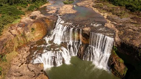 High Angle Aerial View of Sae Pong Lai Waterfall and Volcanic Rock Formations Stock Photos
