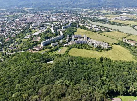 High angle aerial view showing suburban apartment complexes beside wooded h.. Stock Photos