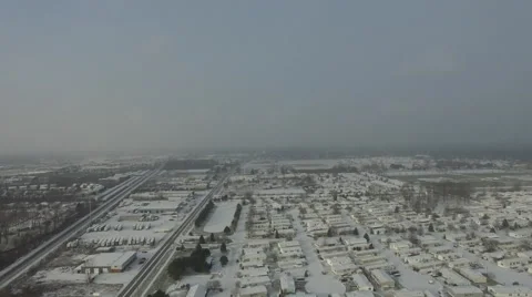 High Angle Aerial View of snow covered residential area as snow falls Stock Footage 60026027