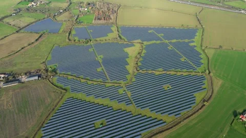 High angle aerial view tracking past thousands of blue solar panel modules on a Stock Footage 337005085