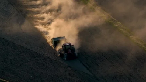 High angle aerial view of tractor on field making a dust cloud Stock Footage 242258985